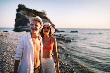 Happy young couple in love walking on seashore on vacation