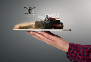 Sticker - Farmer holding a tablet with autonomous tractor and drone. Smart farming