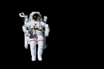 Wall Mural - astronaut with a jetpack isolated on black background with copy space - elements of this image are f