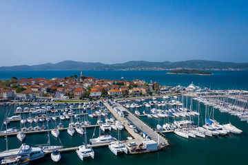 Canvas Print - Aerial View of Yacht Club and Marina in Biograd na Moru. Summer time in Dalmatia region of Croatia. Coastline and turquoise water and blue sky. Photo made by drone from above.