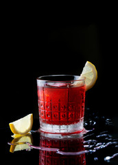 Wall Mural - Fresh red colorful exotic alcoholic cocktail with lemon and ice