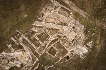 Archaeological ancient ruins of ancient buildings in Crimea, aerial top down view