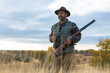 © Mountains Hunter - Hunter with a hat and a gun in search of prey in the steppe