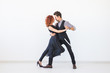 © satura_ - Social dance, kizomba, tango, salsa, people concept - beautiful couple dancing bachata on white background with copy space