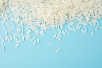 Wall Mural - White rice isolated on blue background on top view food object design