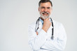 © opolja - Cheerful mature doctor posing and smiling at camera, healthcare and medicine.
