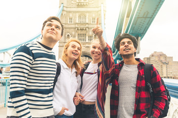 Happy students on Tower Bridge in London during school trip