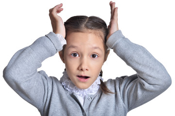 Wall Mural - Portrait of cute little girl posing on white background