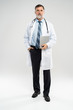 © opolja - full body picture of a mature doctor holding a notepad, on white background.