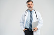 © opolja - Cheerful mature doctor posing and smiling at camera, healthcare and medicine.