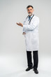 © opolja - Doctor senior man, medical professional holding something in empty hand isolated over white background.