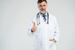 © opolja - Happy smiling doctor with thumbs up gesture, isolated on white background.