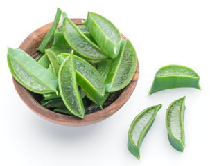 Wall Mural - Fresh aloe vera slices in the wooden bowl on white background.