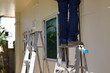 © sutichak - repairman worker standing on ladder