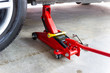 © piyaphunjun - red tool jack lift car for repair check Maintenance of cars