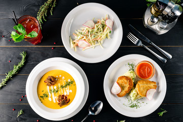 Canvas Print - Enjoy your meal. Set of three delicious dishes served on a restaurant table