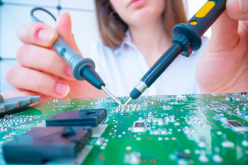Wall Mural - Girl with measuring devices in the electronics laboratory