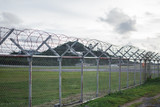 Fototapeta  - wire mesh steel with green grass background in Phuket Thailand
