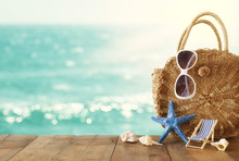 Vacation And Summer Concept With Sea Life Style Objects Over Wooden Table Infront Of Sea Landscape Background