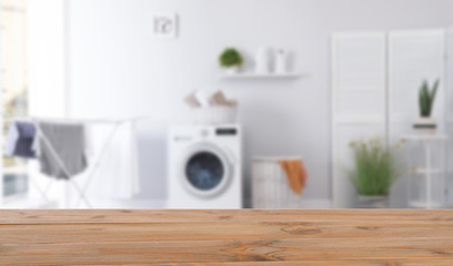 Laundry room interior with washing machine near wall