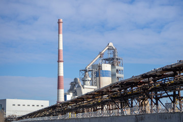 Plant for the production of cement. Industrial zone. Industrial buildings and chimney pipes.