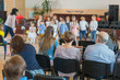 © jollier_ - Performance by talented children. Children on stage perform in front of parents. image of blur kid 's show on stage at school , for background usage. Blurry