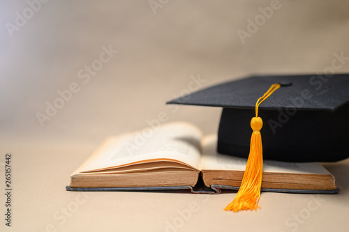 Black Graduation Hats placed on open books