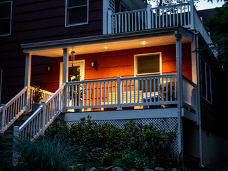 Wall Mural - red suburban house front facade and patio at dusk