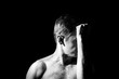 © Serhii  Holdin - black and white photo, a man holds his hands in the face in an expressive pose
