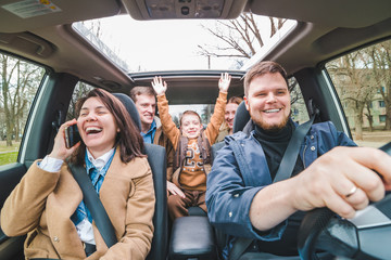 car travel concept. people in car rise up hands