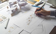 © Chaosamran_Studio - architect design working drawing sketch plans blueprints and making architectural construction model in architect studio
