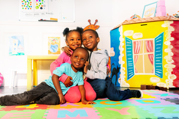 Wall Mural - Group of kids boys and girls hug in play room