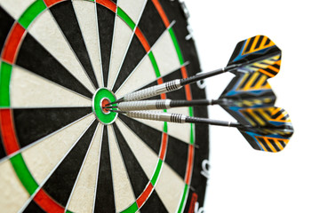 Dart in bulls eye of dartboard with shallow depth of field concept for hitting target