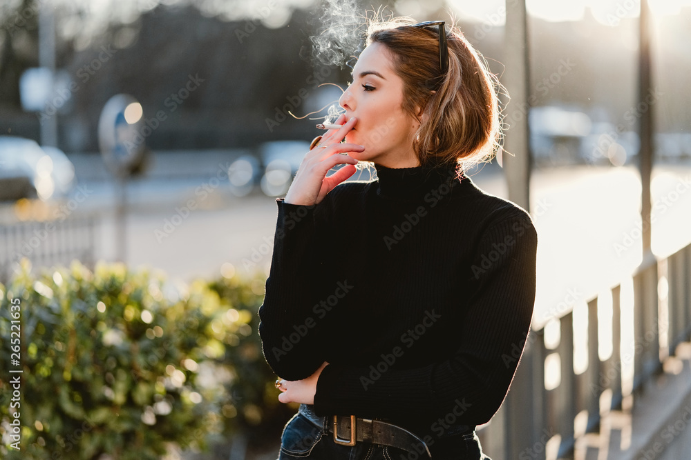 Pretty woman smoking on street Stock Photo