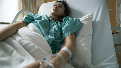 young woman patient sit on bed in hospital