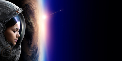 Wall Mural - female astronaut in space on planet orbit.