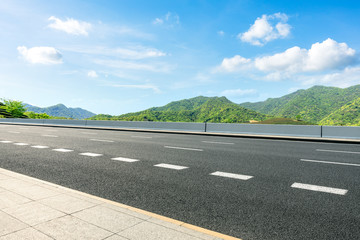 Country road and green mountains natural landscape under the blue sky