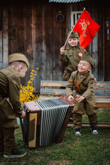 young child in military uniform on holiday day of victory, May 9, Russia.