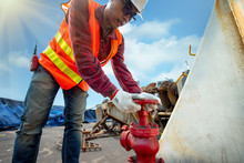 Hand Of Engineer Motorman Or Fireman Opening Or Closing Water Valve In Fire Fighter In Jobsite  During Training Or Inspecting,  Fire Fighting Checking In Safety Priority