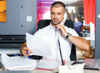 Portrait successful Businessman entrepreneur working at busy office