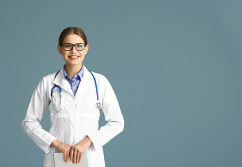 Portrait of young gynecologist on grey background