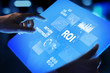 © WrightStudio - ROI Return on investment reading revenue business concept on virtual screen.