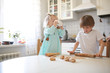 © natalialeb - children make cookies in the kitchen on the table
