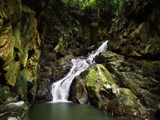 Beautiful silky smooth waterfall stream in the jungle of rainforest Sabah, Borneo.