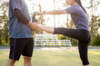 © snowing12 - Early morning workout, Fitness couple stretching outdoors in park. Young man and woman exercising together in morning, Living healthy lifestyle fitness, sport concept.