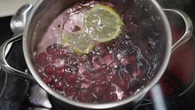 Add Slice Of Lemon In Pan With Water And Berries. Red, Black Currant, Raspberry