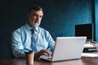 © opolja - Senior man in office working on laptop computer