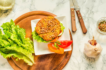 Baked vegan burgers with beans and seeds, vegetables and herbs. Healthy lifestyle and balanced food concept. Top view.