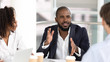 © fizkes - African american businessman coach negotiator speaking at diverse team meeting