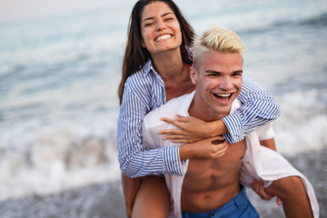 Happy couple having fun and love on the beach